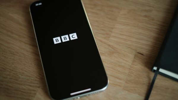 A cell phone sitting on top of a wooden table