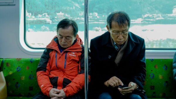 two men sitting inside passenger vehicle