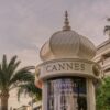 A cannes sign sits below a decorative structure.