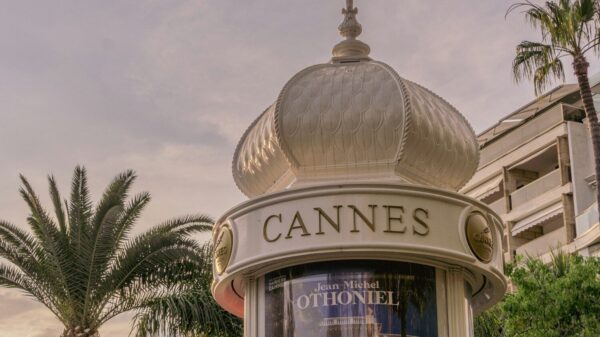 A cannes sign sits below a decorative structure.