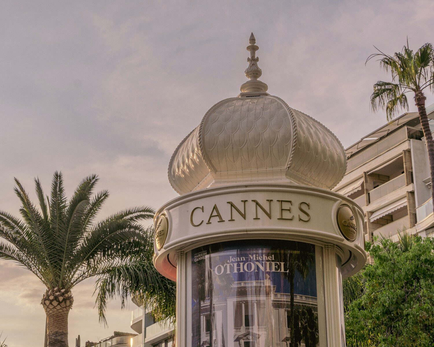 A cannes sign sits below a decorative structure.