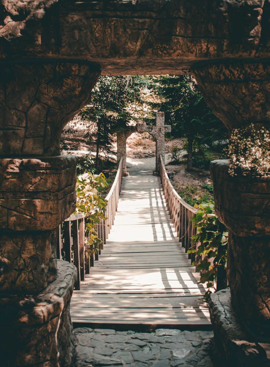 A stone bridge with a walkway going through it