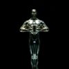 A golden trophy statue isolated on a black background symbolizing achievement and victory.