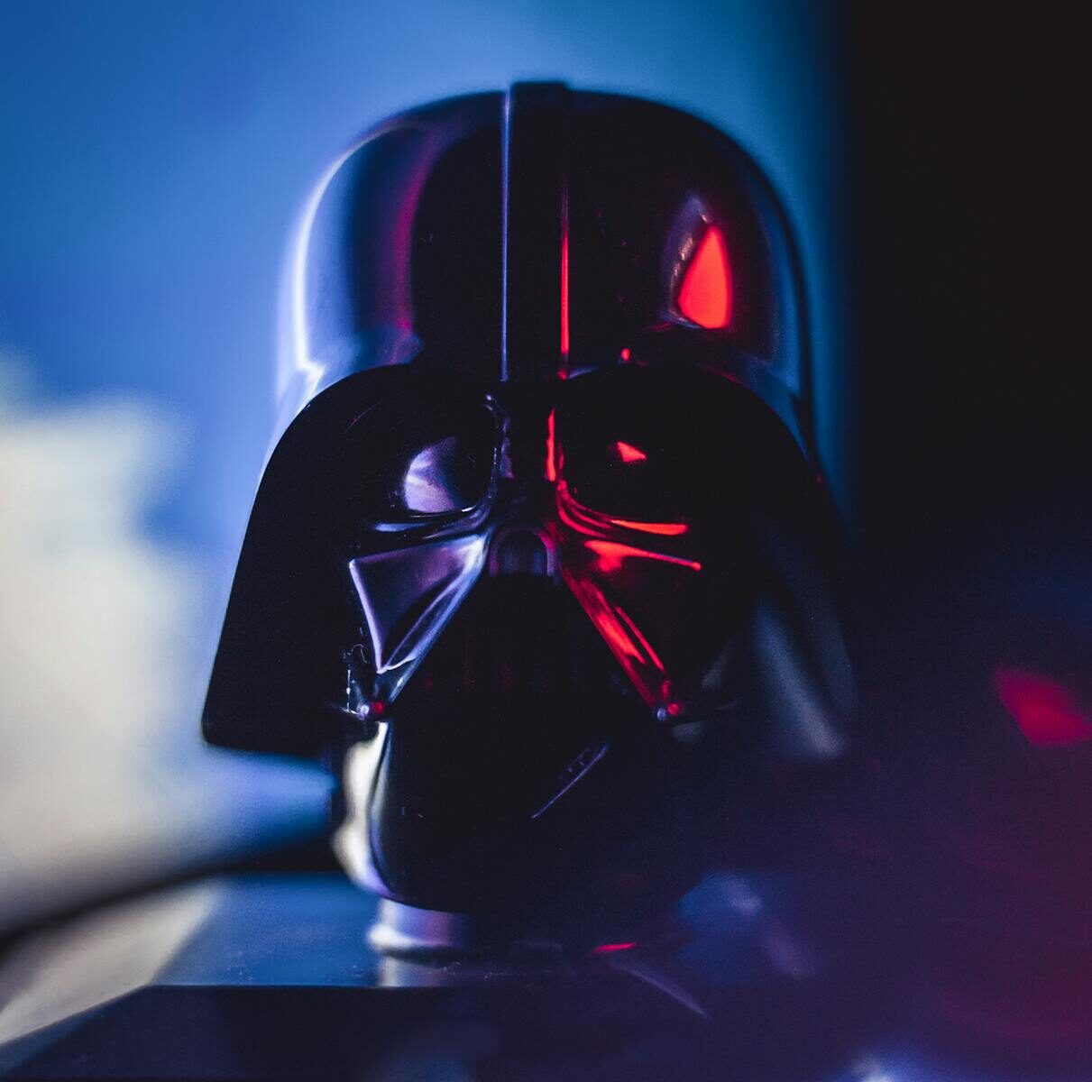 Close-up of a Darth Vader mask with striking lighting effects, showcasing cinematic appeal.