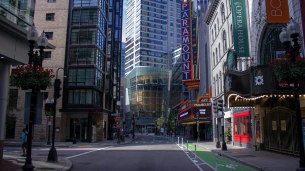 A quiet street in downtown Boston showcasing iconic Paramount marquee and urban architecture.