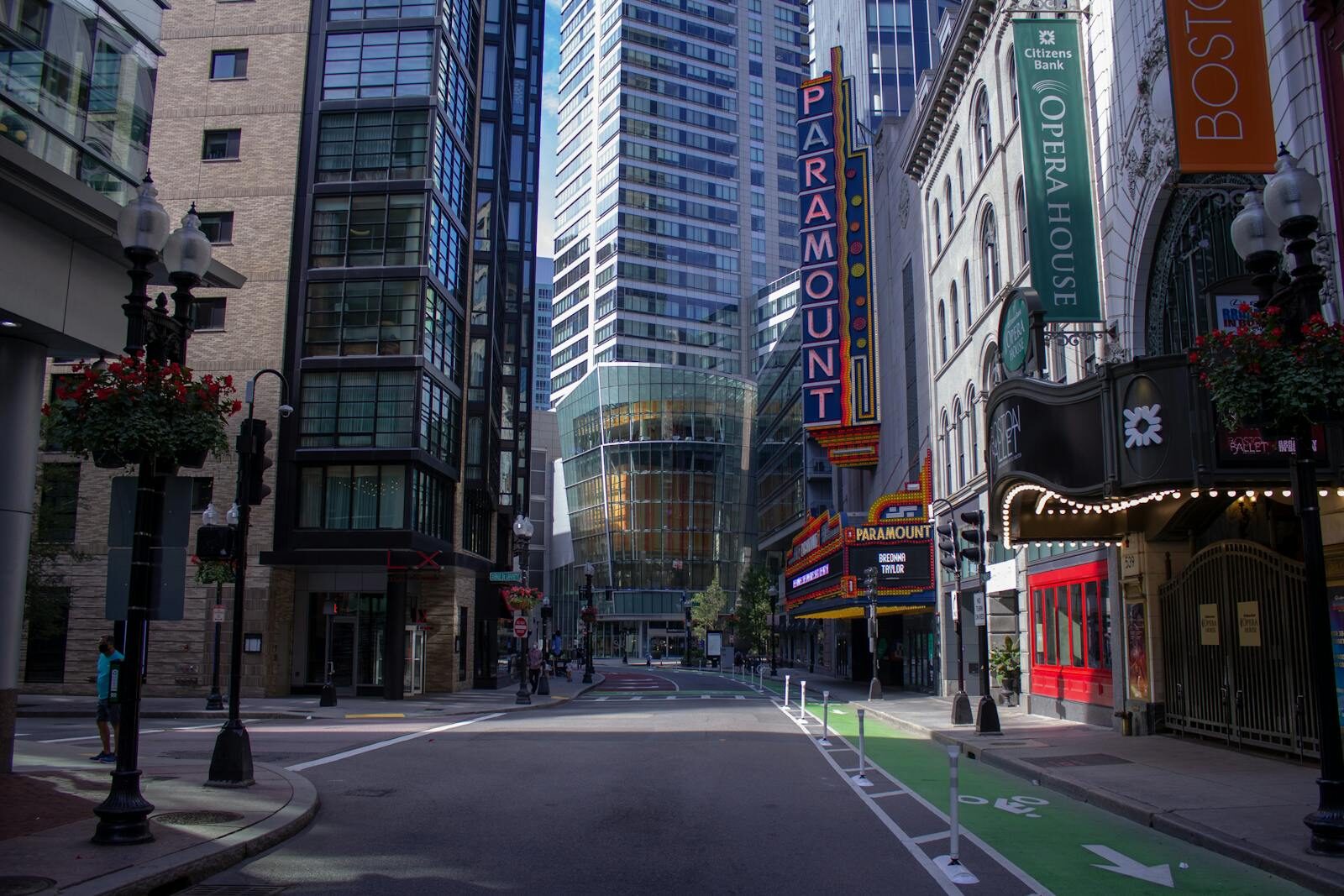 A quiet street in downtown Boston showcasing iconic Paramount marquee and urban architecture.