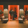 A cozy retro cinema room showcasing vintage film projectors and comfortable seating.