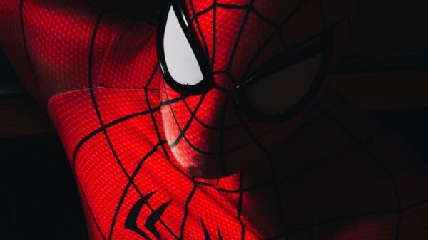 High contrast image of a person in a Spider-Man costume with dramatic lighting.