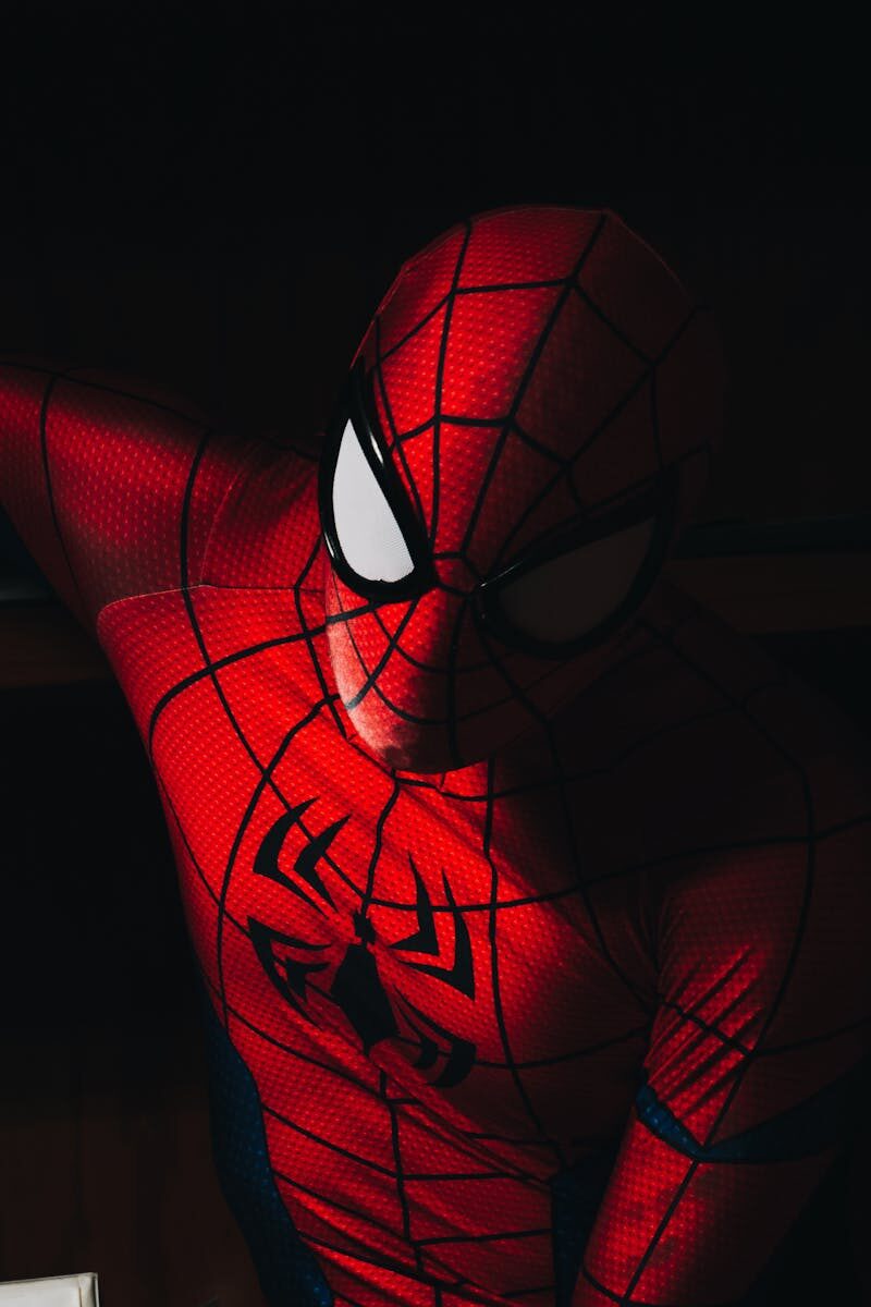 High contrast image of a person in a Spider-Man costume with dramatic lighting.