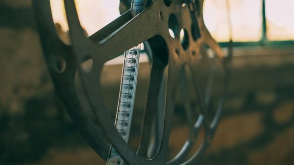 Artistic shot of a vintage film reel with soft light creating a nostalgic atmosphere.