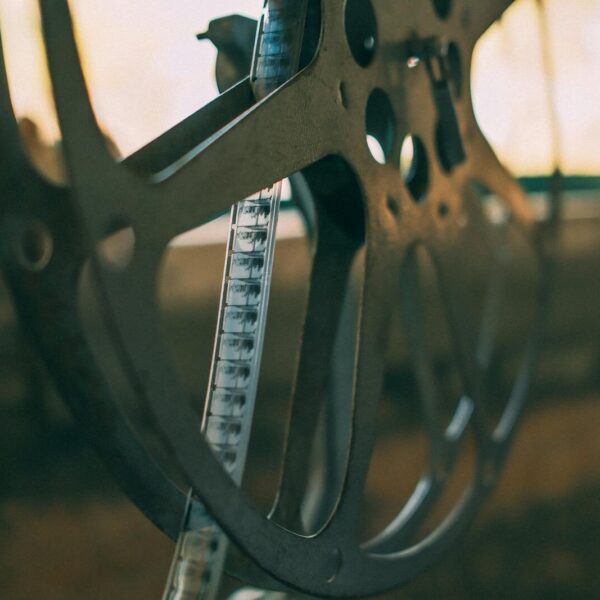Artistic shot of a vintage film reel with soft light creating a nostalgic atmosphere.