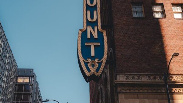 Vertical shot of Paramount Theater facade, capturing urban architecture and iconic signage.