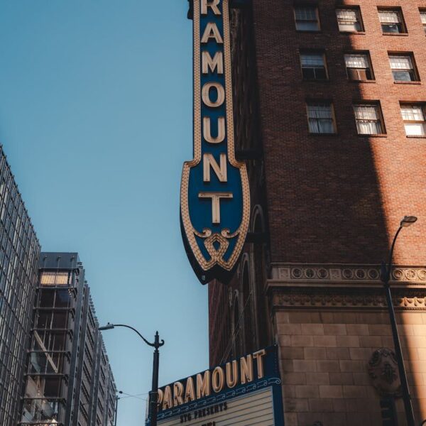 Vertical shot of Paramount Theater facade, capturing urban architecture and iconic signage.