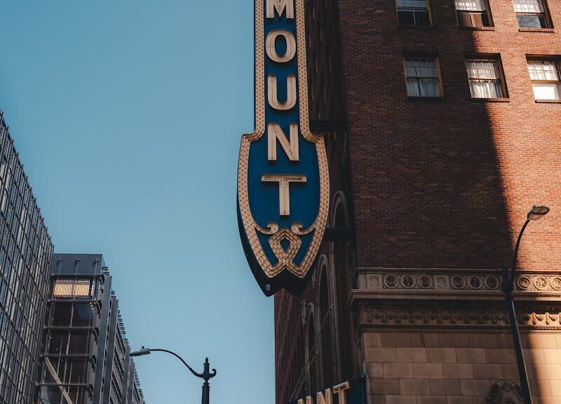 Vertical shot of Paramount Theater facade, capturing urban architecture and iconic signage.