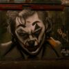 Dramatic Joker-themed graffiti in Leake Street Tunnel, London showcasing urban street art.