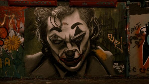 Dramatic Joker-themed graffiti in Leake Street Tunnel, London showcasing urban street art.