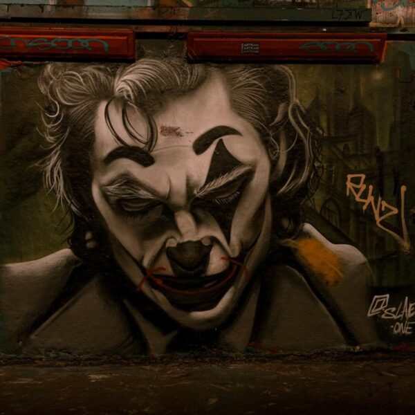 Dramatic Joker-themed graffiti in Leake Street Tunnel, London showcasing urban street art.