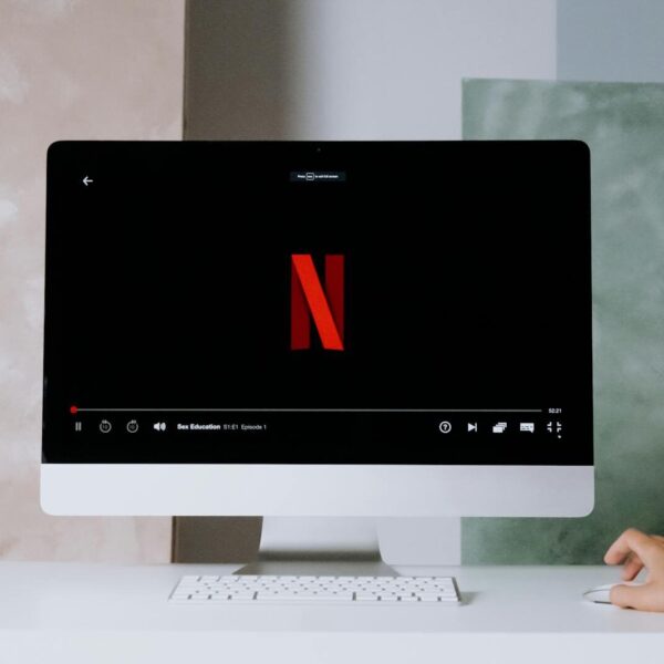 A minimalist workspace scene featuring a desktop displaying a streaming service, ideal for modern lifestyle themes.