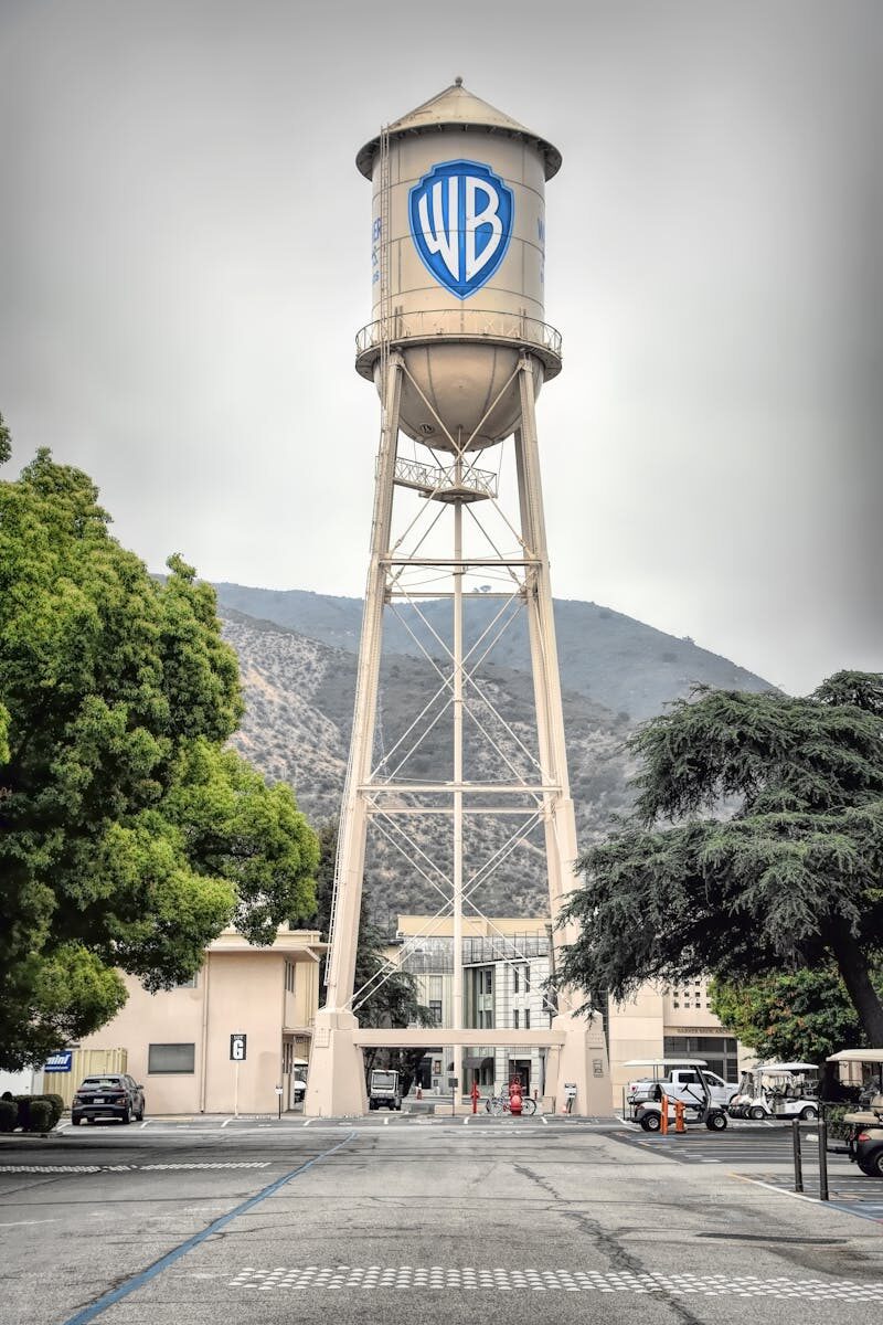 Iconic Warner Bros Studio water tower in Burbank, showcasing urban architecture against a mountain backdrop.