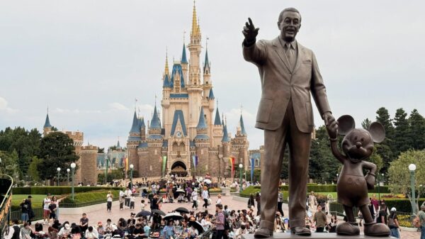 Statue of Walt Disney and Mickey Mouse in front of Cinderella Castle, Tokyo Disneyland.