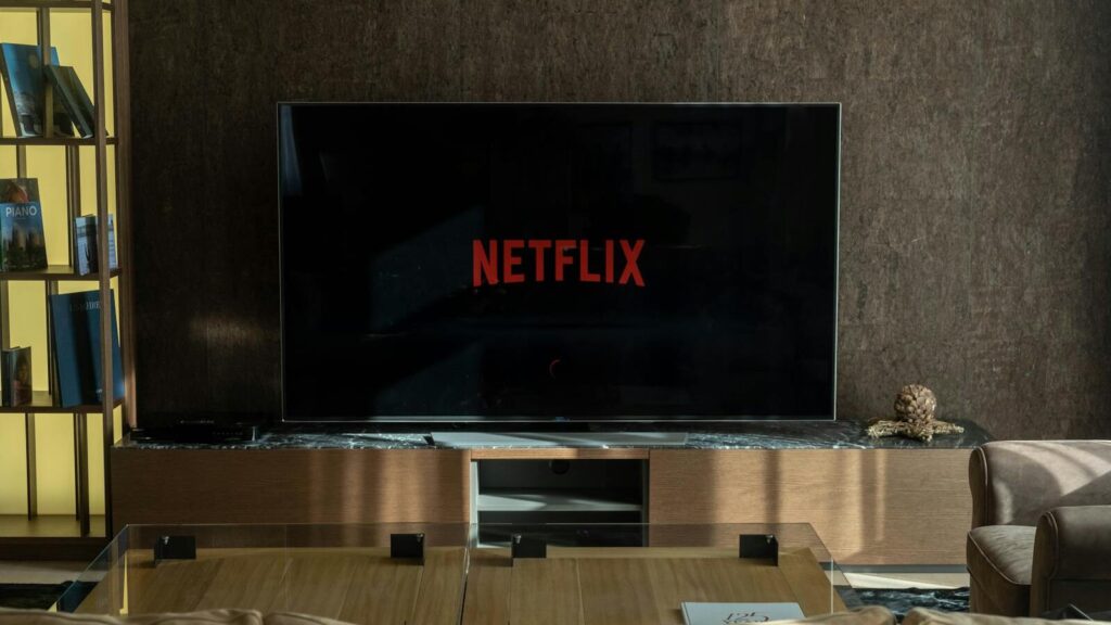 Cozy living room featuring a large TV displaying Netflix, perfect for entertainment.