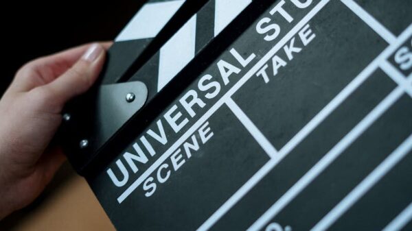 A detailed view of a Universal Studios clapboard held in hands, perfect for film industry concepts.