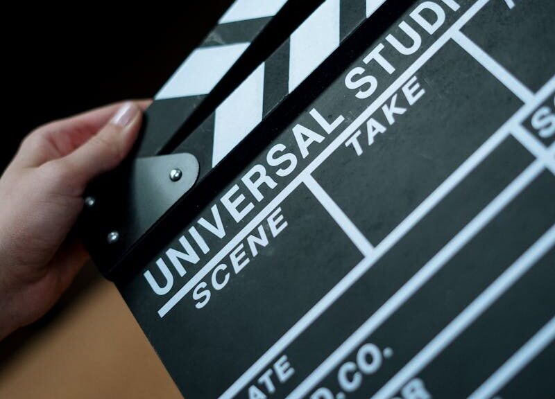 A detailed view of a Universal Studios clapboard held in hands, perfect for film industry concepts.