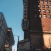 Vertical shot of Paramount Theater's distinctive facade in city environment.