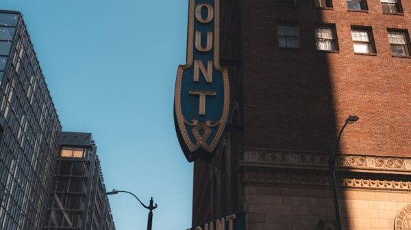 Vertical shot of Paramount Theater's distinctive facade in city environment.
