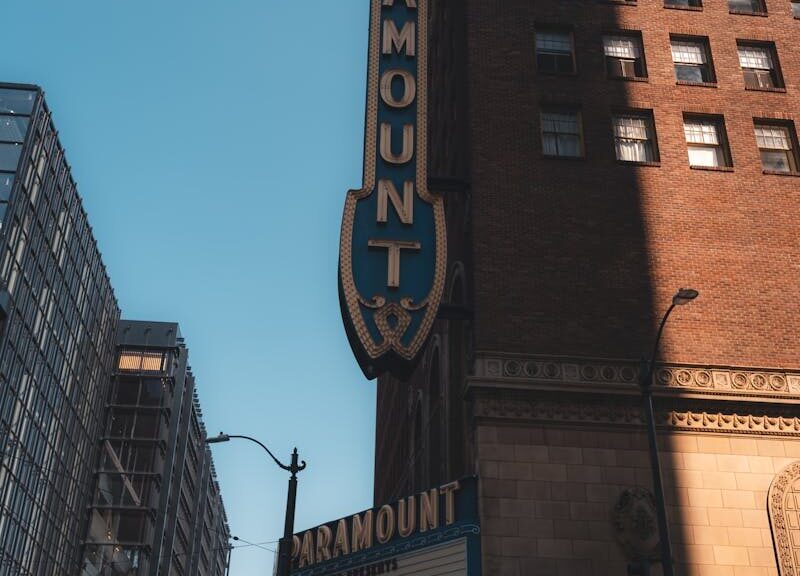 Vertical shot of Paramount Theater's distinctive facade in city environment.