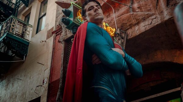 A superhero cosplayer poses in vibrant San Francisco Chinatown under neon lights.