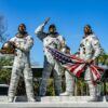 Statue of Apollo astronauts holding an American flag at Kennedy Space Center, Florida.