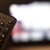 black remote control on brown wooden table