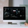 A modern desktop displays a streaming service interface, showcasing entertainment options in a minimalist office setting.