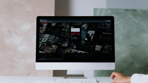 A modern desktop displays a streaming service interface, showcasing entertainment options in a minimalist office setting.