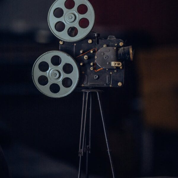 A classic vintage film camera on a tripod, capturing nostalgic cinematic equipment.