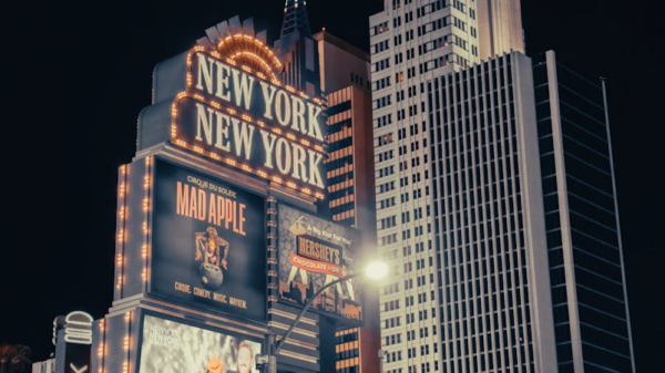 Night view of the iconic New York-New York Hotel in Las Vegas with brilliant lights and modern architecture.