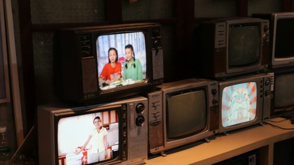 a bunch of tvs that are sitting on a shelf