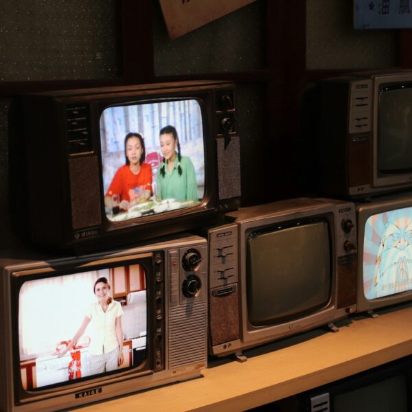 a bunch of tvs that are sitting on a shelf
