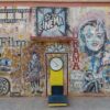 Colorful mural featuring cinematic themes in Ouarzazate, Morocco, with vintage design elements.