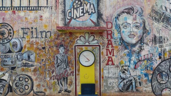 Colorful mural featuring cinematic themes in Ouarzazate, Morocco, with vintage design elements.