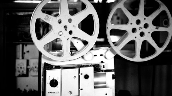 Black and white image of a retro film projector showcasing cinematographic equipment.