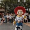 A vibrant Toy Story character parade at Shanghai Disneyland, featuring enthusiastic crowds and lively atmosphere.