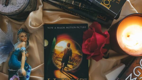 A cozy arrangement featuring fantasy novels, glowing candles, and decorative roses.