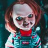 Creative design of doll with redhead and freckles on terrible face representing aggressive character at home