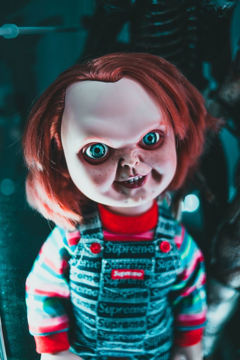 Creative design of doll with redhead and freckles on terrible face representing aggressive character at home