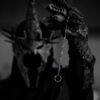 Mystical armored figure with a spiked helmet holding a mysterious ring in focus.