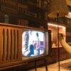 Cozy room with vintage wooden television and modern interior design elements, creating a nostalgic ambiance.
