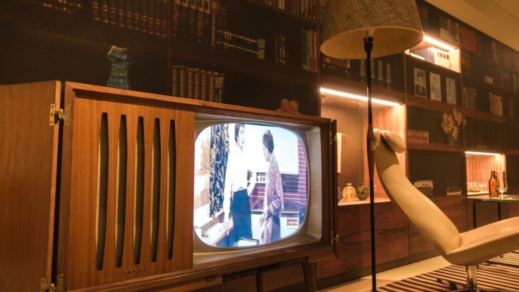 Cozy room with vintage wooden television and modern interior design elements, creating a nostalgic ambiance.