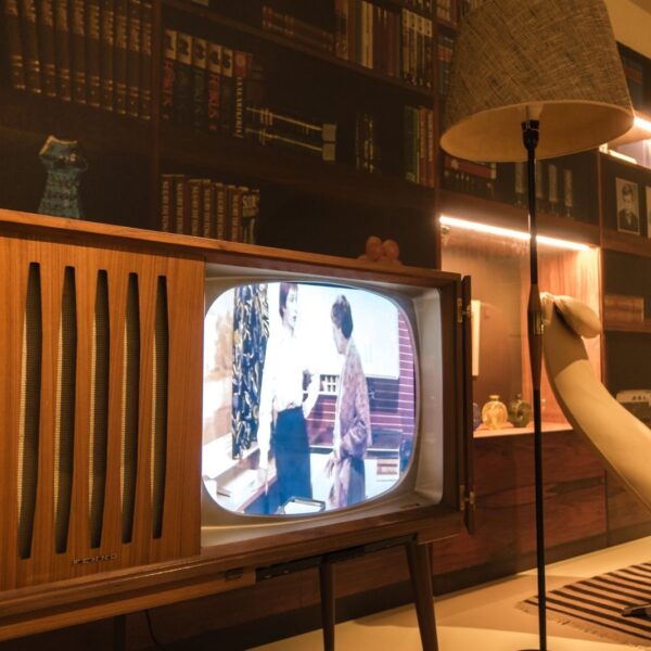 Cozy room with vintage wooden television and modern interior design elements, creating a nostalgic ambiance.